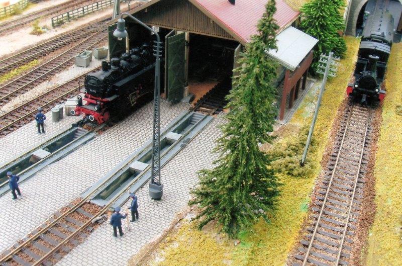 This view of the shed from the operators side of the layout shows the inspection pits and the local train emerging from the fiddle yard on the shuttle line.